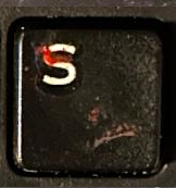 A blood-stained S key.